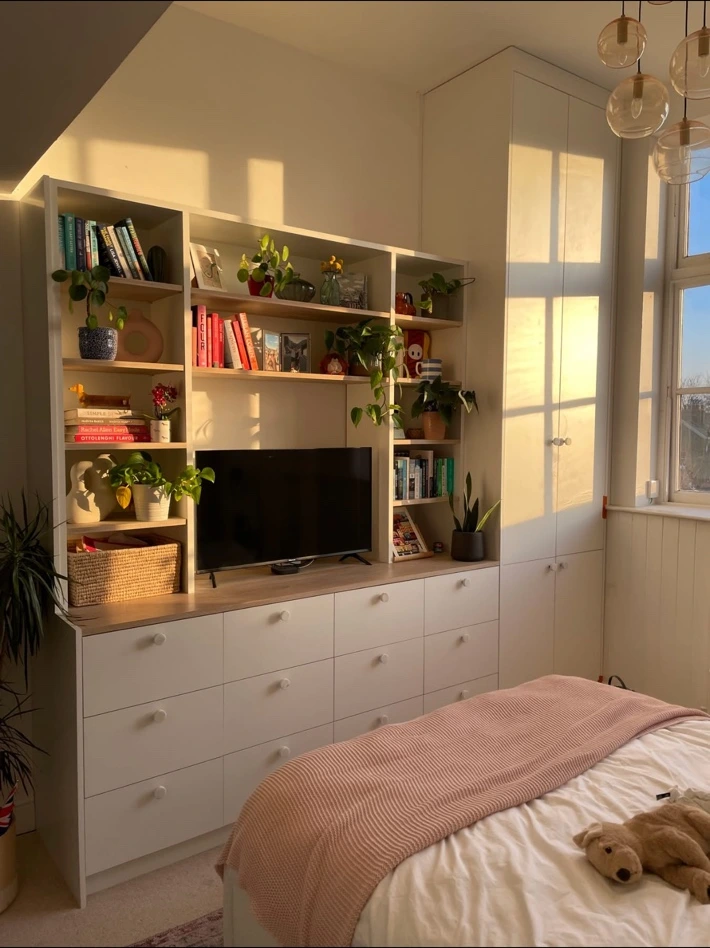 Bespoke fitted bedroom storage, shelving and wardrobe in warm afternoon light