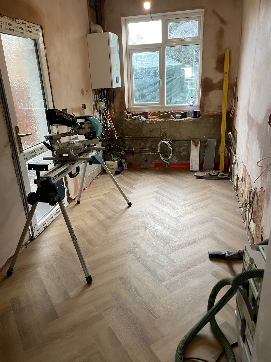 Herringbone flooring being fitted during kitchen renovation